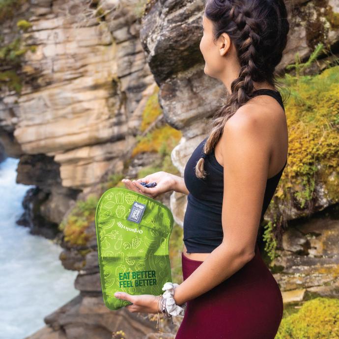 woman eating blueberries out of a custom washable chicobag snack time sancwich and snack bag