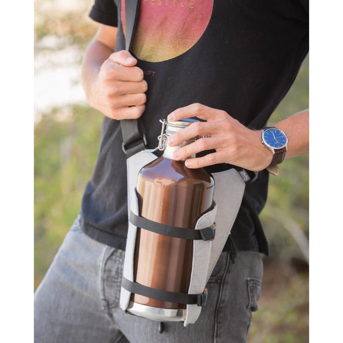 ChicoBag dexluxe bottle sling cross body bottle holder across someones chest with a reusable water bottle in it