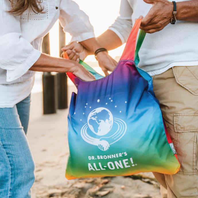 two people holding a Dr. Bronners custom ChicoBag Original reusable Tote bag