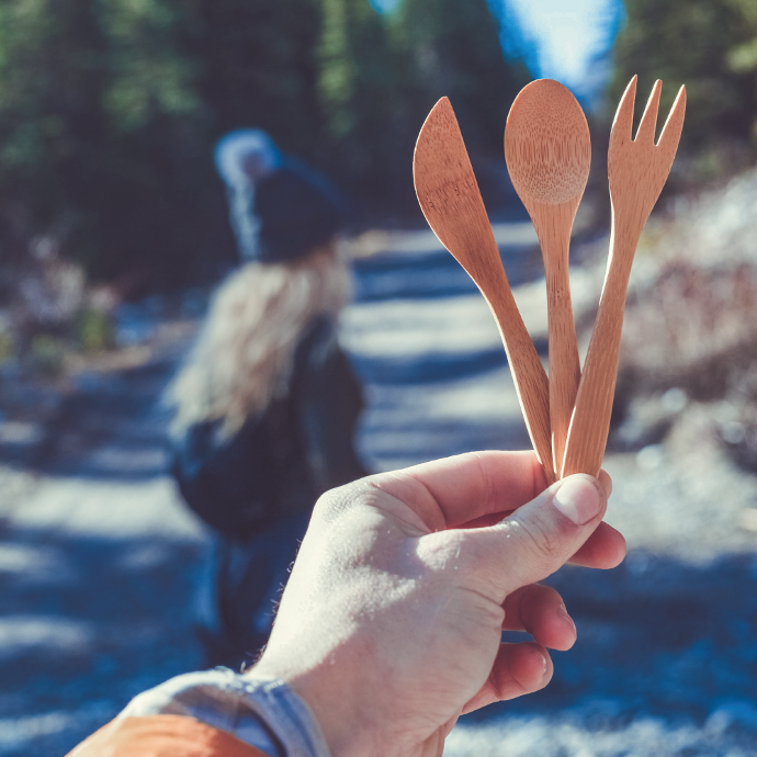 person holding to-go ware reusable packable utensil set utensils while on a walk